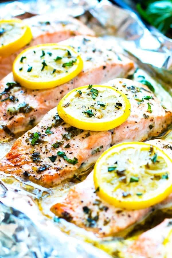 Salmon fillets topped with lemon and basil inside foil packet