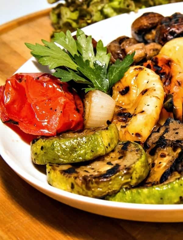 Grilled vegetables and shrimp on white plate