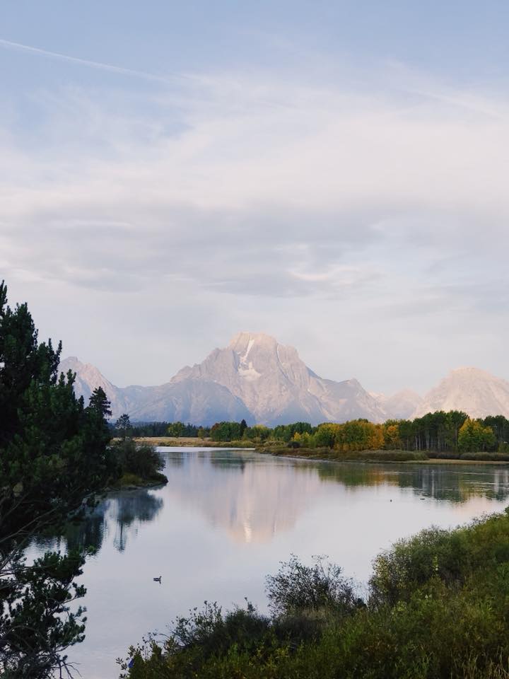A mountain reflecting in the water early in the morning in Grand Teton National Park.