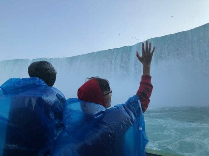 Riding the Maid of the Mist tour boat into the middle of Horseshoe Falls at Niagara Falls New York