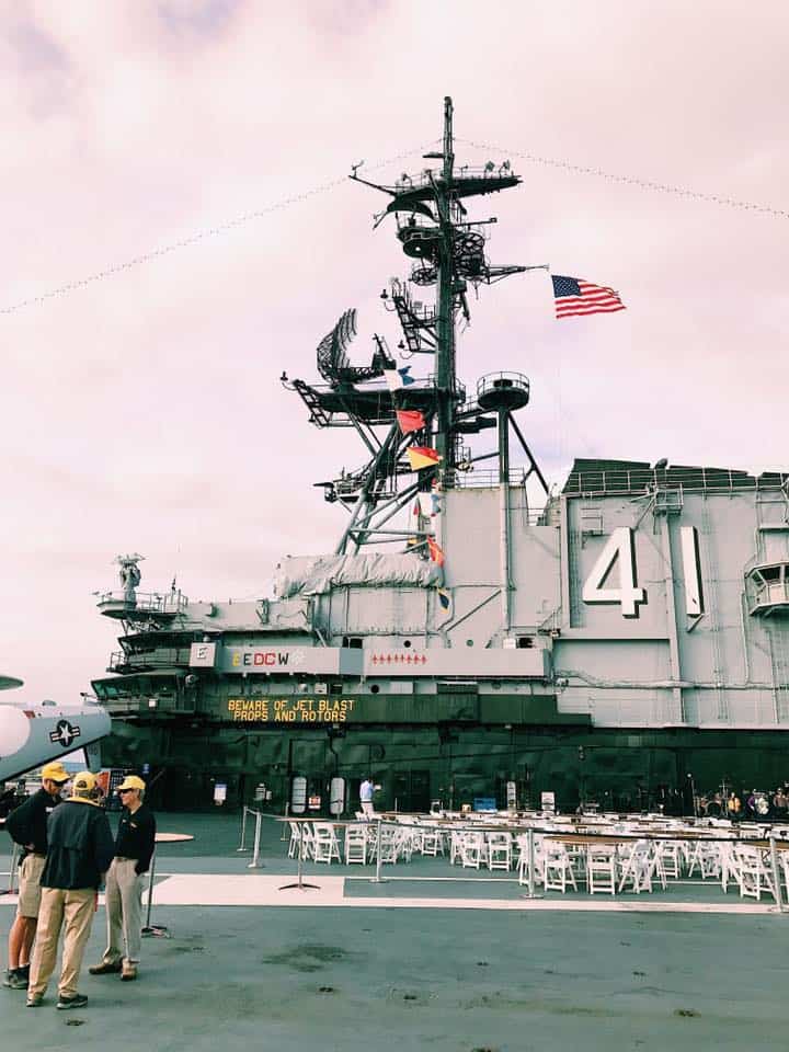 Staff standing in front of USS Midway in San Diego