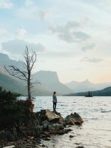 Woman standing near edge of Wild Goose Island while visiting national park