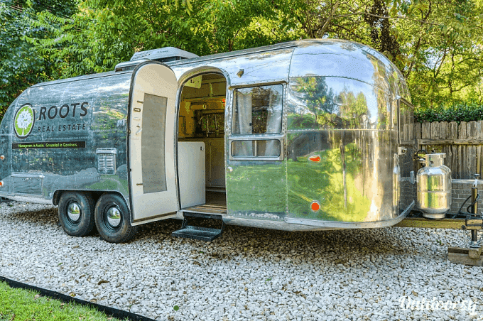 Airstream travel trailer parked in lot and available for rent