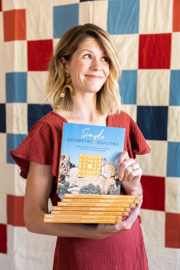 Laura Preston showing her book Simple Geometric Quilting about crafting while RVing