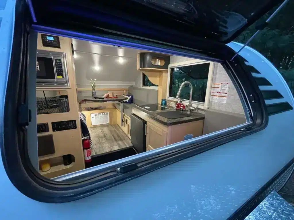 Interior view through window of Little Guy Micro Max travel trailer