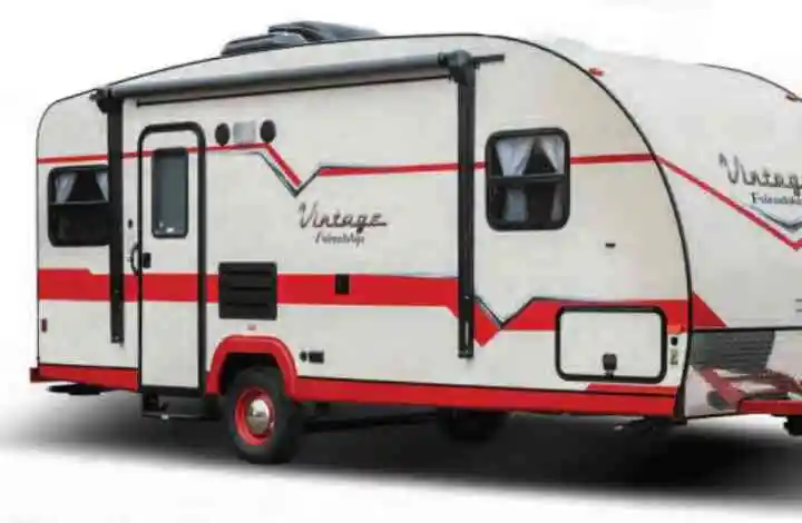 Exterior view of a white with red stripe vintage Gulf Stream RV