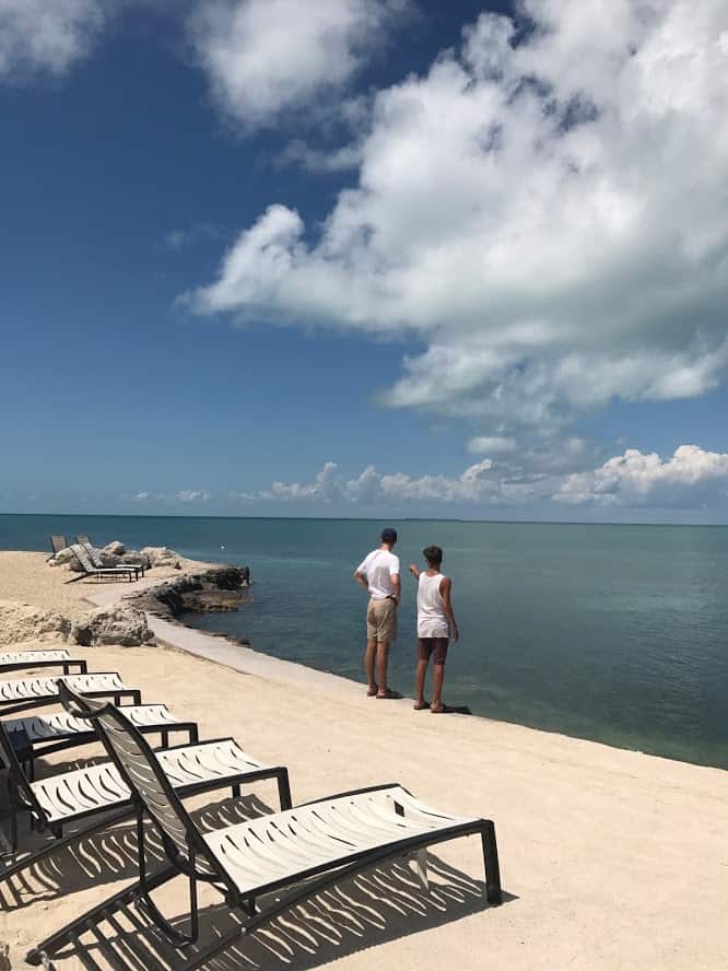 Two men standing near ocean at Fiesta Key RV Resort