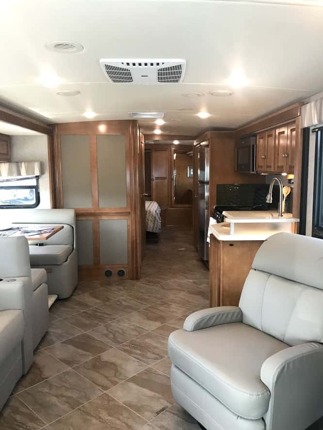 Cushioned recliner and dining area is nice for travelers deciding which RV is best to live in