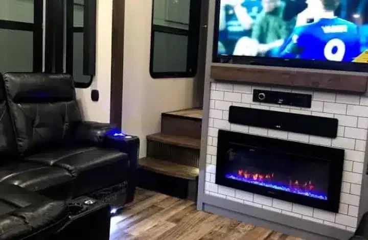 Sofa, TV and fireplace inside Keystone travel trailer