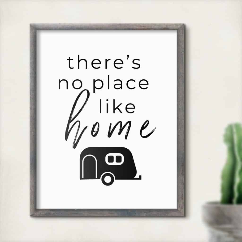 Framed drawing of black and white travel trailer with words 'there's no place like home'