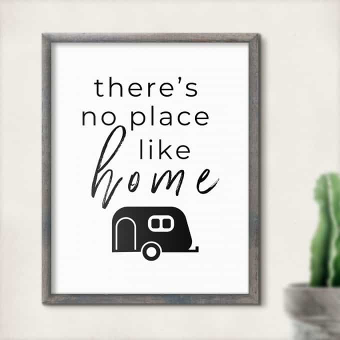 Framed drawing of black and white travel trailer with words 'there's no place like home'