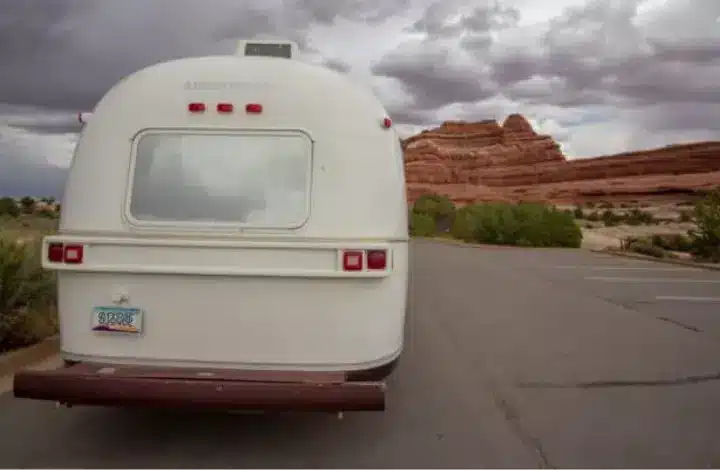Back of white Airstream motorhome traveling through Canyonlands National Park.