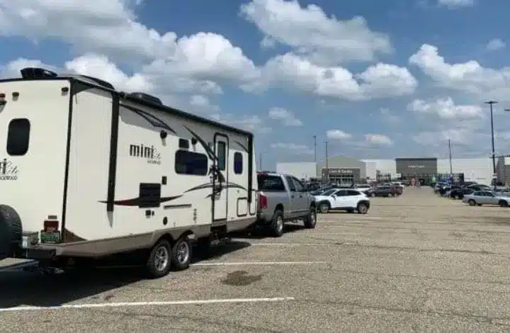 Travel trailer RV parked in Walmart parking lot for free overnight spot