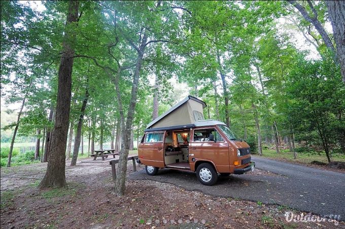 VW Westfalia pop-up camper van rental at campsite