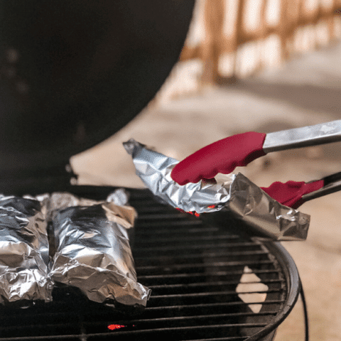 Remove foil packet breakfast burrito from camping grill