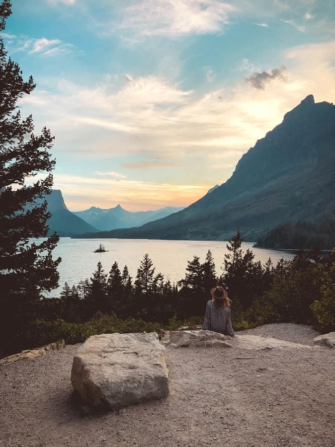Woman sitting with view of Glacier National Park Montana