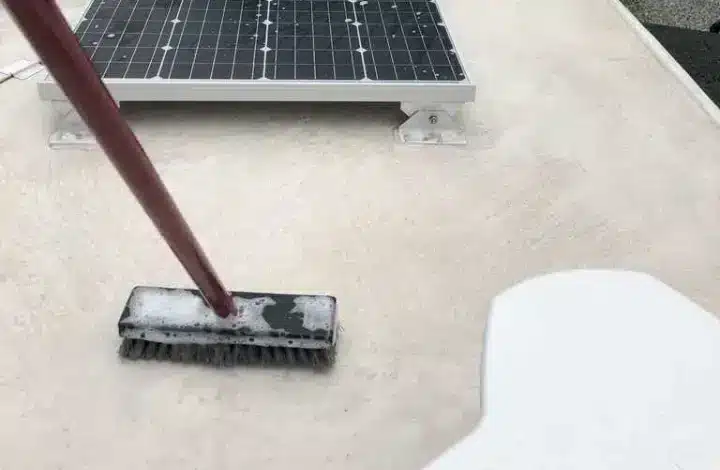 Close up of long handled brush as RV owner washes roof of RV