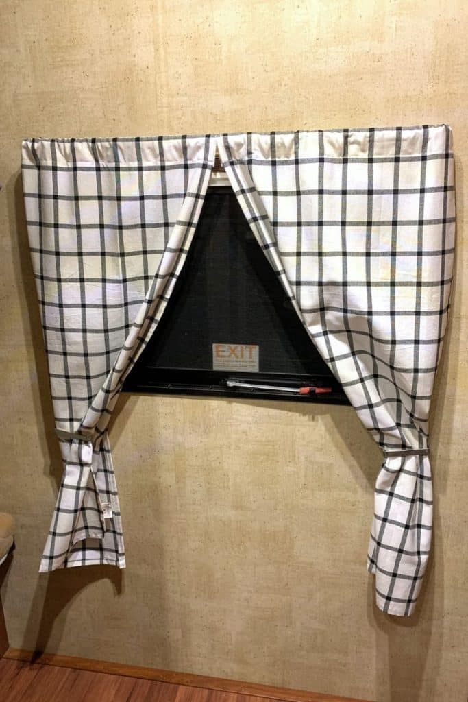 White and blue plaid curtains made by RV owner to personalize interior of their rig