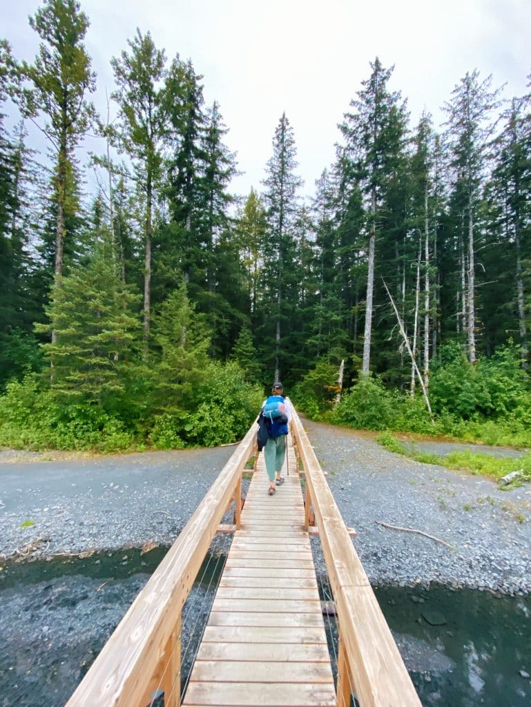Hiker on boardwalk that is par of amazing hiking trails in Seward Alaska
