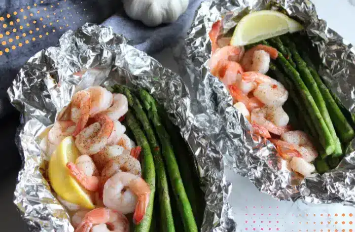 Shrimp, asparagus, lime wrapped in foil for campfire oooking