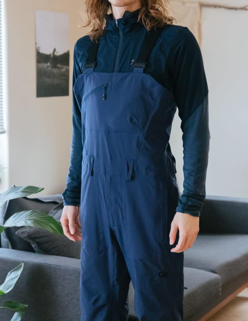 Man wearing blue bib overall pants for layering clothes in winter