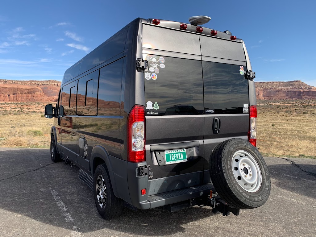 Black campervan with TREKKN license plate parked and ready for first long road trip
