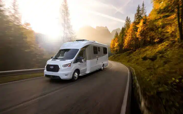A Ford Wonder campervan driving along a scenic road