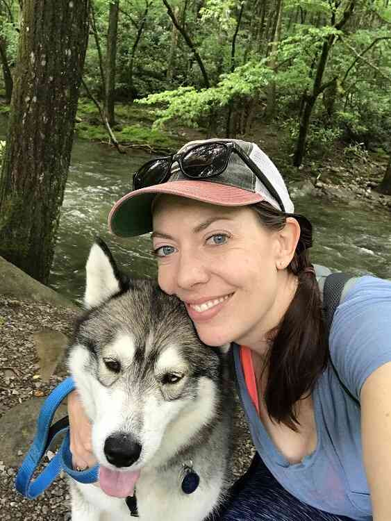 A writer and outdoor explorer, Sarah, with her dog Orion.