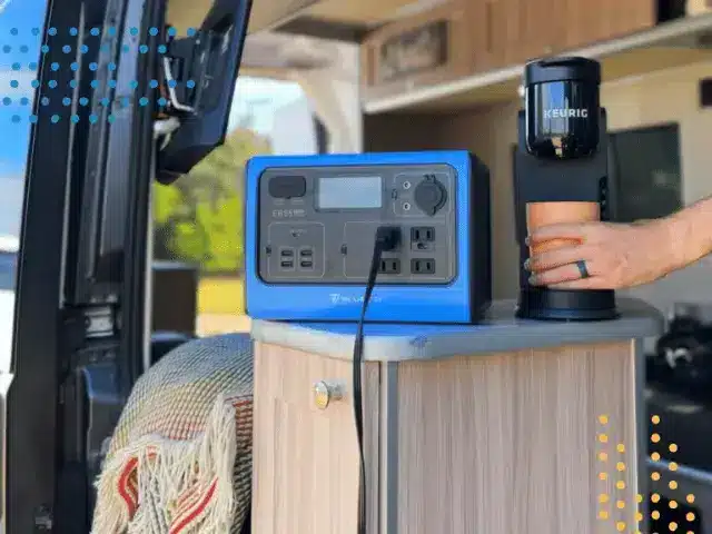 A portable power station inside campervan being used to power small coffee maker