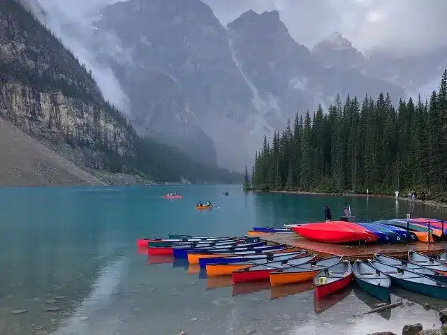 Red, blue and orange canoes docked at Moraine Lake in Banff National Park