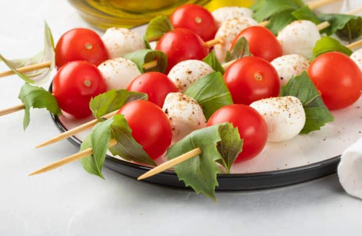 Plate of caprese salad skewers made with cherry tomatoes