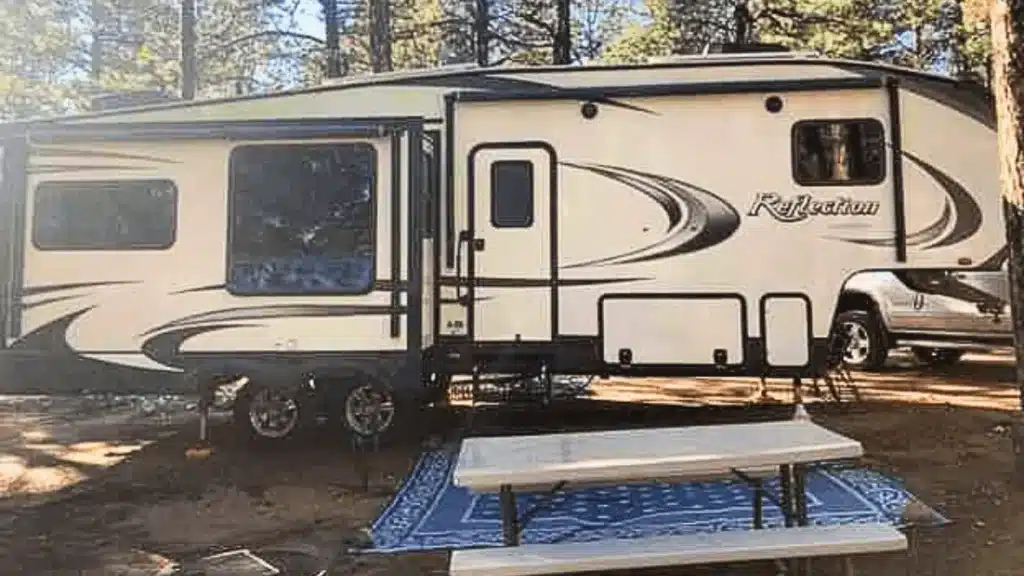 Author's travel trailer parked at campsite next to picnic table