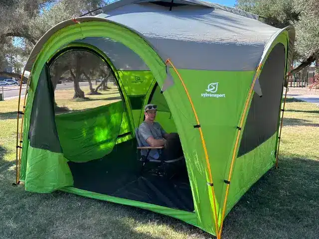Man seated inside GOzeebo tent pitched at park while he tested out the product.