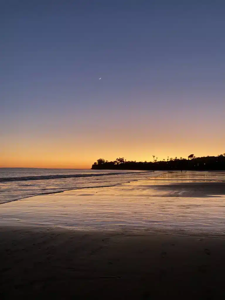 Dark blue sky and disappearing sunset along California beach