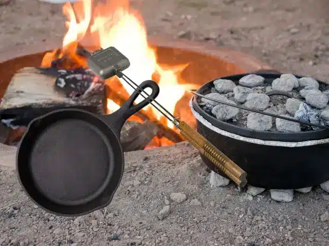 Cast iron skillet, pie iron, and dutch oven by campfire.