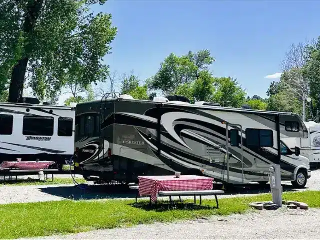 Class C RV parked near picnic table at campsite in Bayfield, Colorado.